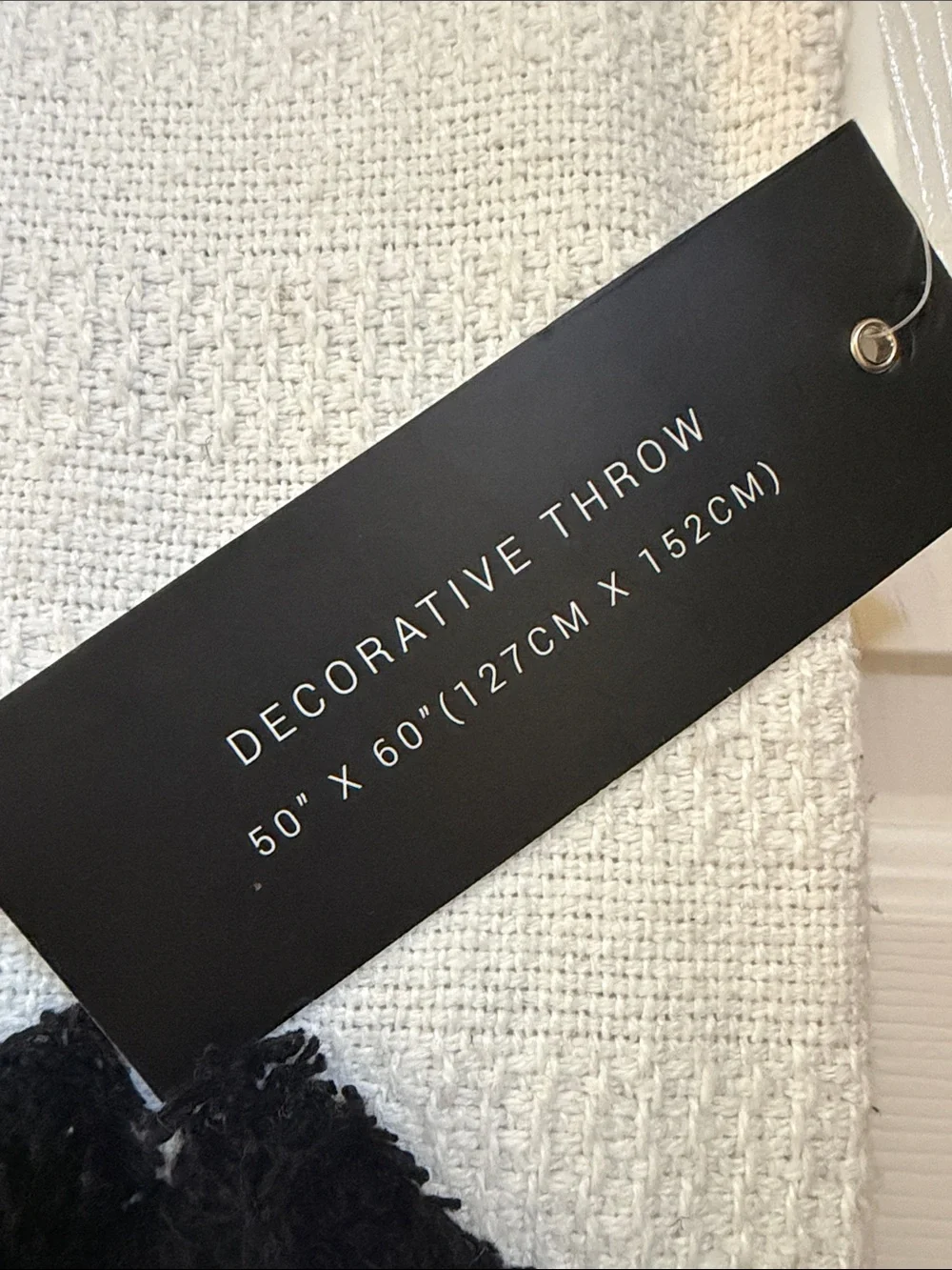 Rachel Zoe White decorative throw with Black Tufted Motifs and Tassel Accents
